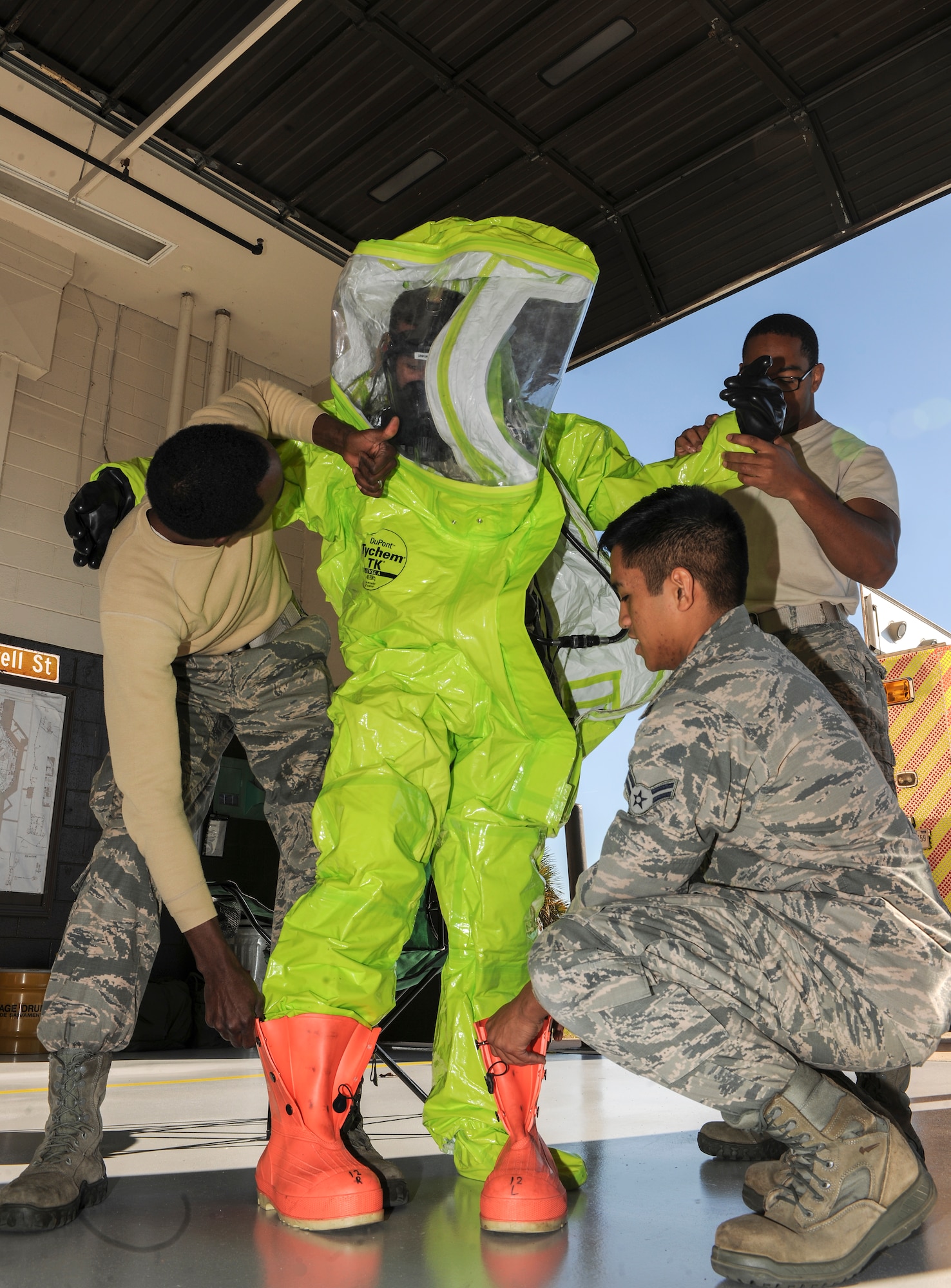 U.S. Air Force Airman 1st Class Brandon Unpingco, 23d Civil Engineer Squadron firefighter, gets dressed in a Level A chemical suit before entering a simulated toxic environment during a hazardous material incident training Jan. 28, 2015, at Moody Air Force Base, Ga. The Level A suit is fully-encapsulating to keep hazardous materials from getting through. (U.S. Air Force photo by Senior Airman Sandra Marrero/Released)
