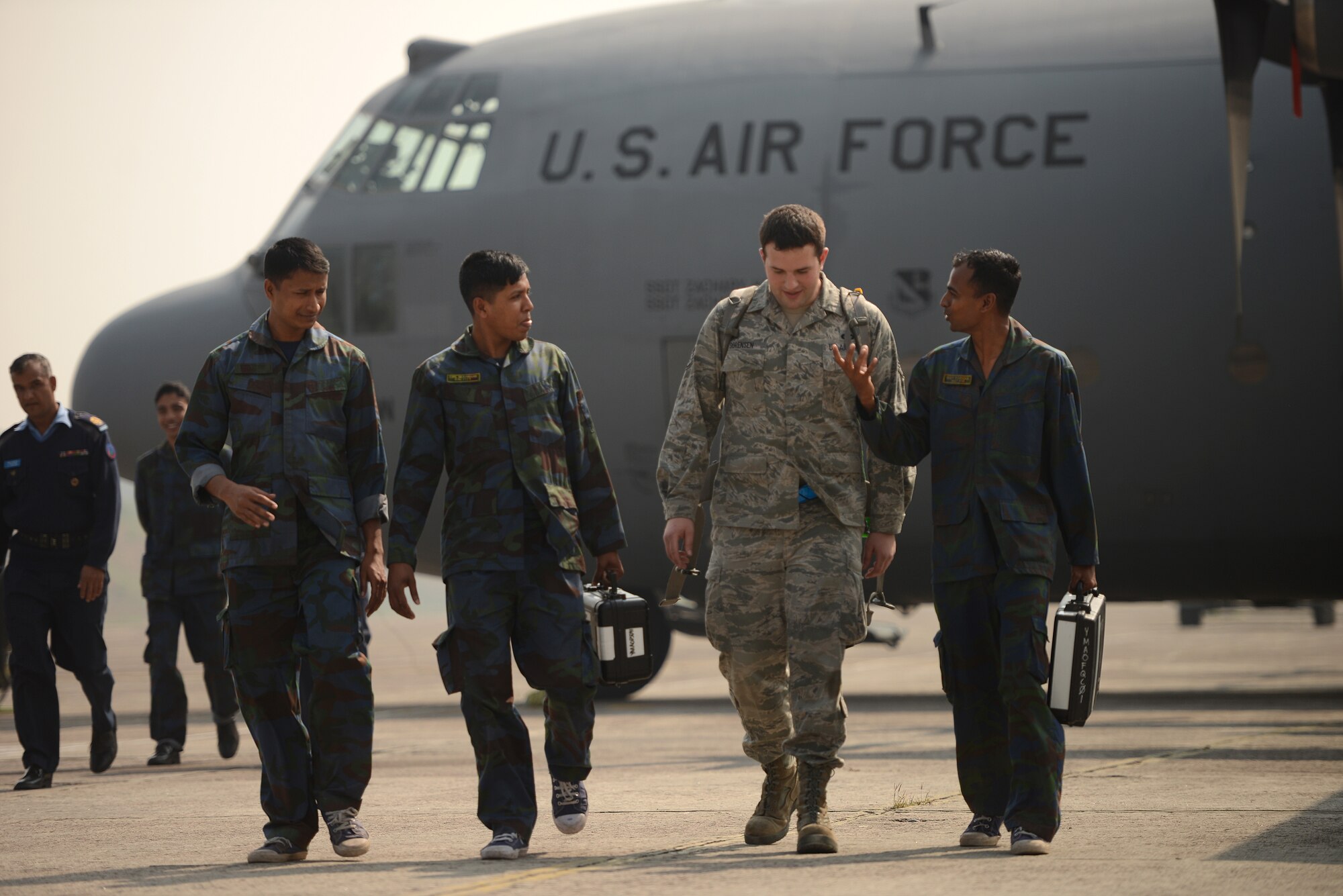U.S. Air Force Staff Sgt. Scott Sorensen discusses C-130 aircraft maintenance considerations with Bangladesh Air Force maintenance personnel during a subject matter expert exchange at Exercise COPE NORTH, BAF Base Bangabandhu, Jan. 27, 2015. Sorensen is a C-130H guidance and control specialist assigned to the 374th Aircraft Maintenance Squadron, Yokota Air Base, Japan. COPE SOUTH is a Pacific Air Forces-sponsored, bilateral tactical airlift exercise conducted in Bangladesh, with a focus on cooperative flight operations, day and night low-level navigation, tactical airdrop, and air-land missions as well as subject-matter expert exchanges in the fields of operations, maintenance and rigging disciplines. (U.S. Air Force photo by 1st Lt. Jake Bailey/Released)