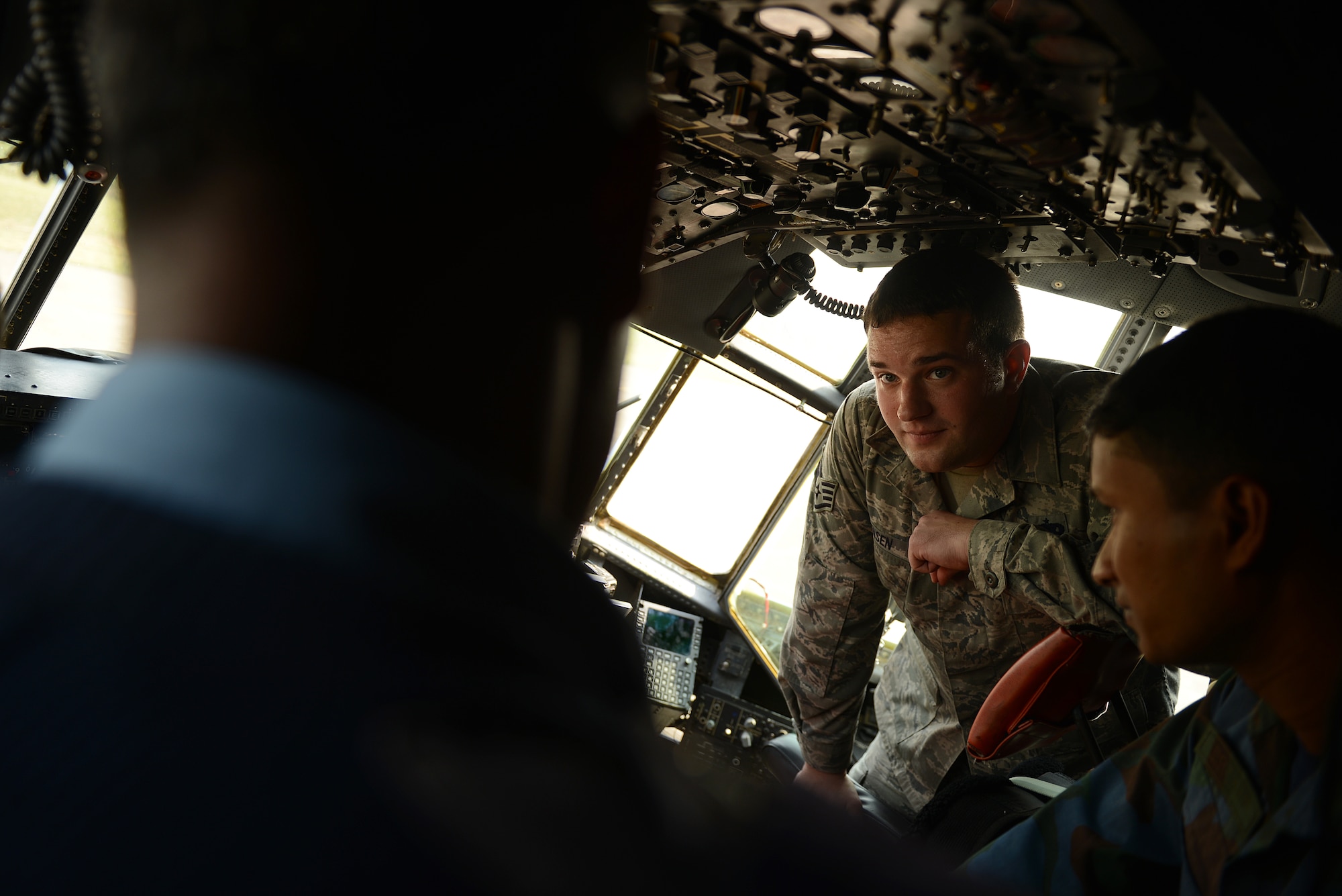 U.S. Air Force Staff Sgt. Scott Sorensen discusses C-130 aircraft control systems maintenance considerations with Bangladesh Air Force personnel during a subject matter expert exchange at Exercise COPE NORTH, BAF Base Bangabandhu, Jan. 27, 2015. Sorensen is a C-130H guidance and control specialist assigned to the 374th Aircraft Maintenance Squadron, Yokota Air Base, Japan. COPE SOUTH is a Pacific Air Forces-sponsored, bilateral tactical airlift exercise conducted in Bangladesh, with a focus on cooperative flight operations, day and night low-level navigation, tactical airdrop, and air-land missions as well as subject-matter expert exchanges in the fields of operations, maintenance and rigging disciplines. (U.S. Air Force photo by 1st Lt. Jake Bailey/Released)