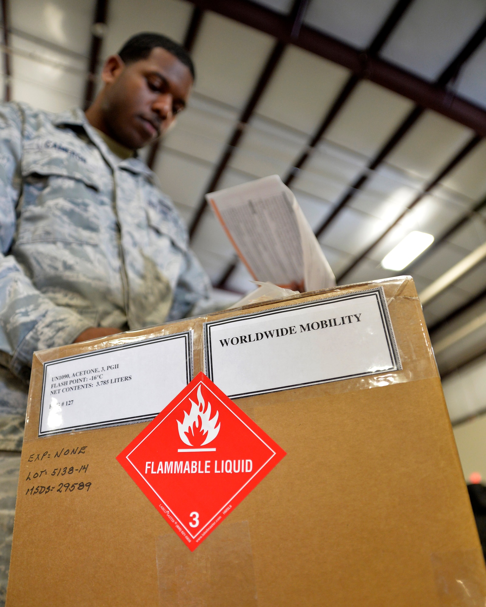 Senior Airman Aubrey Cameron, 99th Logistics Readiness Squadron Creech traffic management specialist, checks a material safety data sheet for transportation information and regulation guidelines Jan. 28, 2015, at Creech Air Force Base, Nevada. With parts, equipment, and incoming and outgoing cargo constantly being moved, the squadron has an equipment accountability management element to track all items, parts, and tools needed to support Creech AFB’s various missions, from RPA operations to base defense. (U.S. Air Force photo by Staff Sgt. Adawn Kelsey/Released)