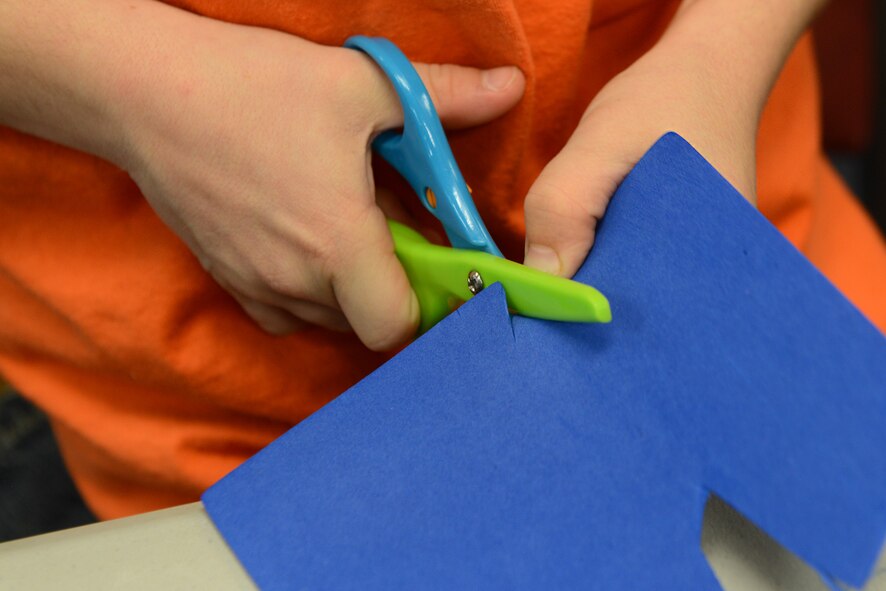 Kyler Brown, son of deployed U.S. Air Force Tech. Sgt. Jonathan Brown, 23d Civil Engineering Squadron heavy equipment operator, makes a card during the Deployed and Remote Family Dinner Jan. 29, 2015, at Moody Air Force Base, Ga. All the children at the event made arts and crafts to send to their deployed parent. (U.S. Air Force photo by Airman 1st Class Kathleen D. Bryant/Released)