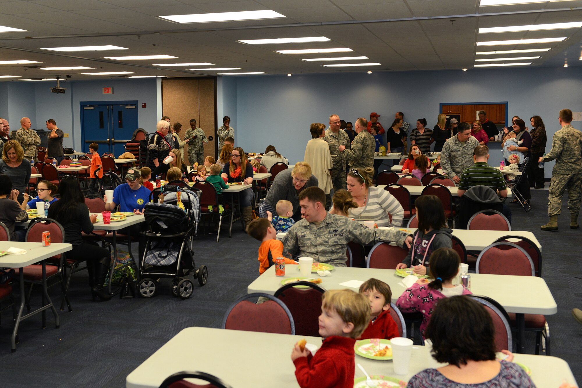 Families of deployed service members enjoy a meal during the Deployed and Remote Family Dinner Jan. 29, 2015, at Moody Air Force Base, Ga. Events for deployed Airmen are held quarterly by the base chapel and Airman & Family Readiness Center. (U.S. Air Force photo by Airman 1st Class Kathleen D. Bryant/Released)