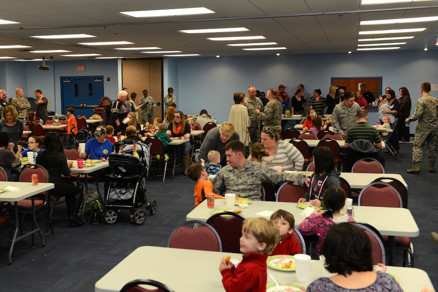 Families of deployed service members enjoy a meal during the Deployed and Remote Family Dinner Jan. 29, 2015, at Moody Air Force Base, Ga. Events for deployed Airmen are held quarterly by the base chapel and Airman & Family Readiness Center. (U.S. Air Force photo by Airman 1st Class Kathleen D. Bryant/Released)