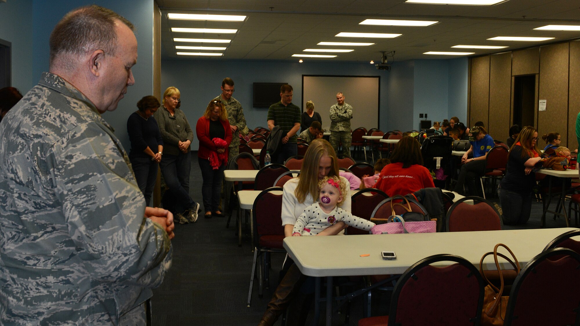 U.S. Air Force Maj. Kim Bowen, 23d Wing chaplain, blesses the meal held for families during the Deployed and Remote Family Dinner Jan. 29, 2015, at Moody Air Force Base, Ga. Families of 33 deployed service members enjoyed a meal and participated in activities during the event. (U.S. Air Force photo by Airman 1st Class Kathleen D. Bryant/Released)