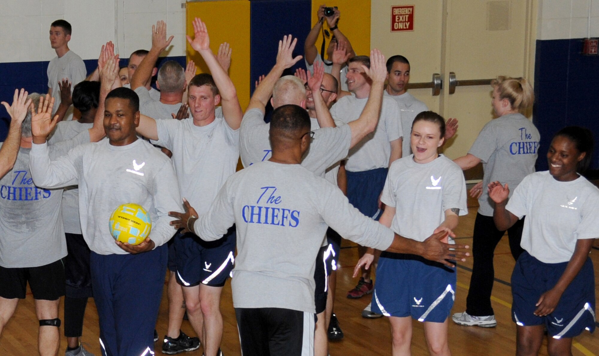 High-fives are given following the volleyball matches between the Chiefs Group and Airmen Leadership School students Jan. 29, 2015, at the Blake Fitness Center, Keesler Air Force Base, Miss.  The friendly game is played during every ALS class which teaches students teamwork and mentorship.  The chiefs defeated ALS, beating them two games to one.  (U.S. Air Force photo by Kemberly Groue)
