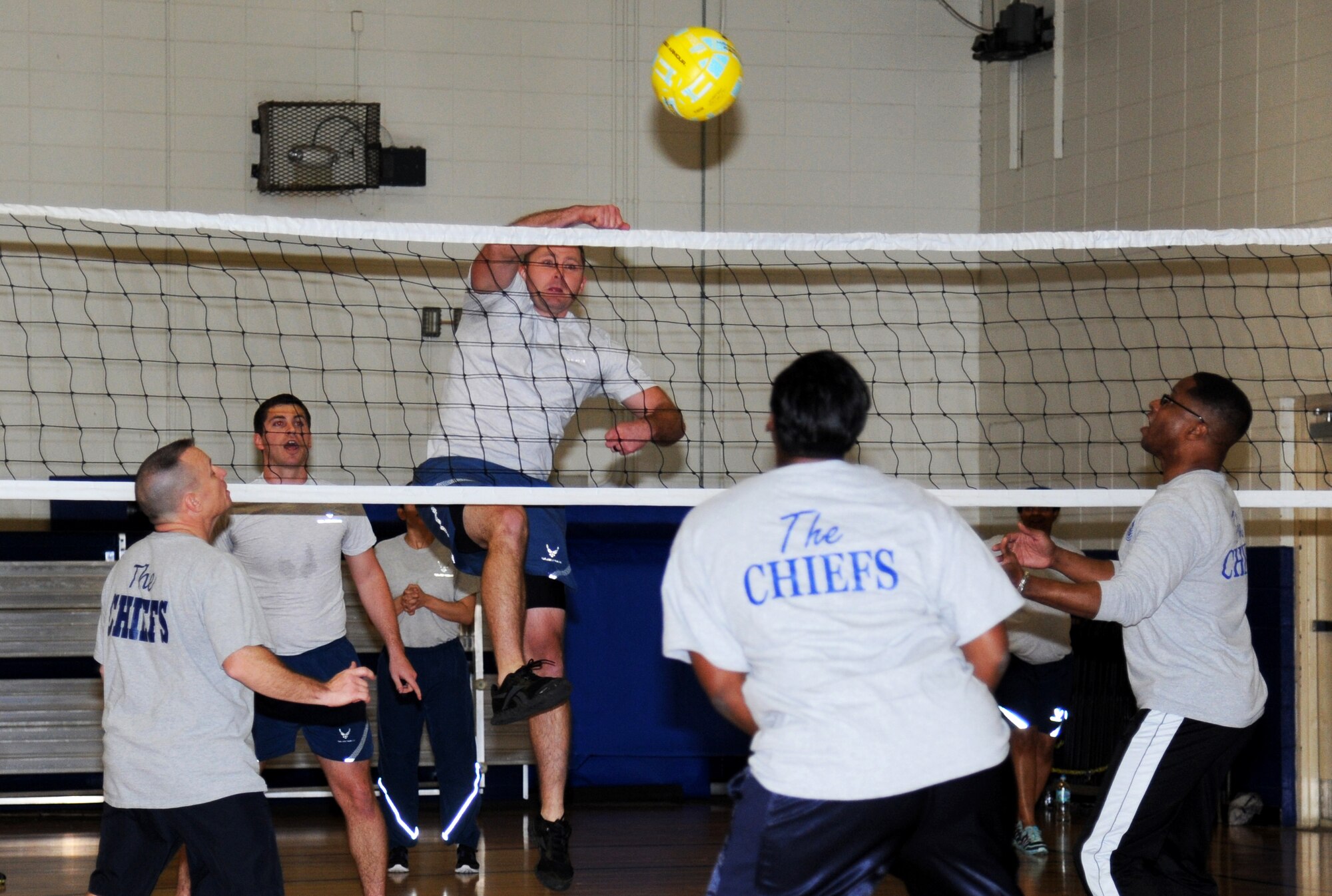 Senior Airman Mathew Theisen, 81st Infrastructure Division firefighter and Airman Leadership School student, spikes the ball during a volleyball match between the Chiefs Group and ALS students Jan. 29, 2015, at the Blake Fitness Center, Keesler Air Force Base, Miss.  The friendly game is played during every ALS class which teaches students teamwork and mentorship.  The chiefs defeated ALS, beating them two games to one.  (U.S. Air Force photo by Kemberly Groue)