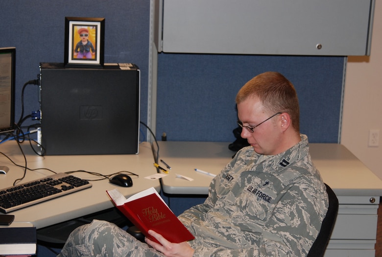 PETERSON AIR FORCE BASE, Colo. -- Chaplain (Capt.) Richard Casey, 21st Space Wing Chaplain’s office, takes advantage of some study time while setting up his new office in Building 350. He relocated his office from the chapel Jan. 20 to be nearer the units so he is closer to where people conduct their daily routine, reaching them where they are as opposed to them having to go to the chapel. (U.S. Air Force photo by Dave Smith)