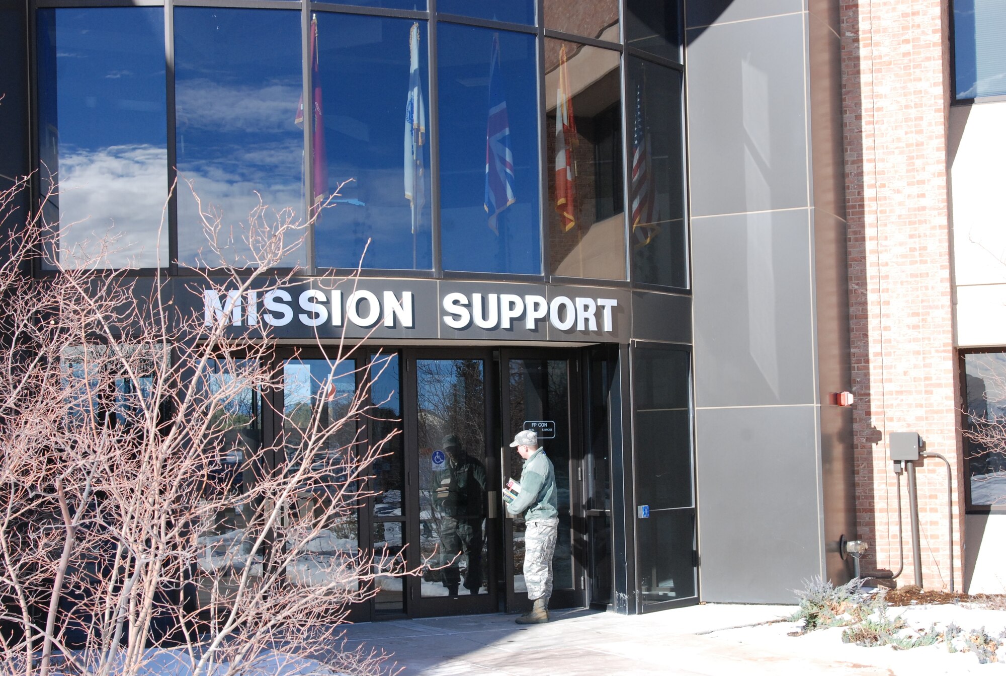 PETERSON AIR FORCE BASE, Colo. -- Chaplain (Capt.) Richard Casey, 21st Space Wing Chaplain’s office, carries books to his new office in building 350. Having his office outside of the chapel allows Casey to be where there are more people and reflects a change in ministry focus to engaging people in their units. (U.S. Air Force photo by Dave Smith)