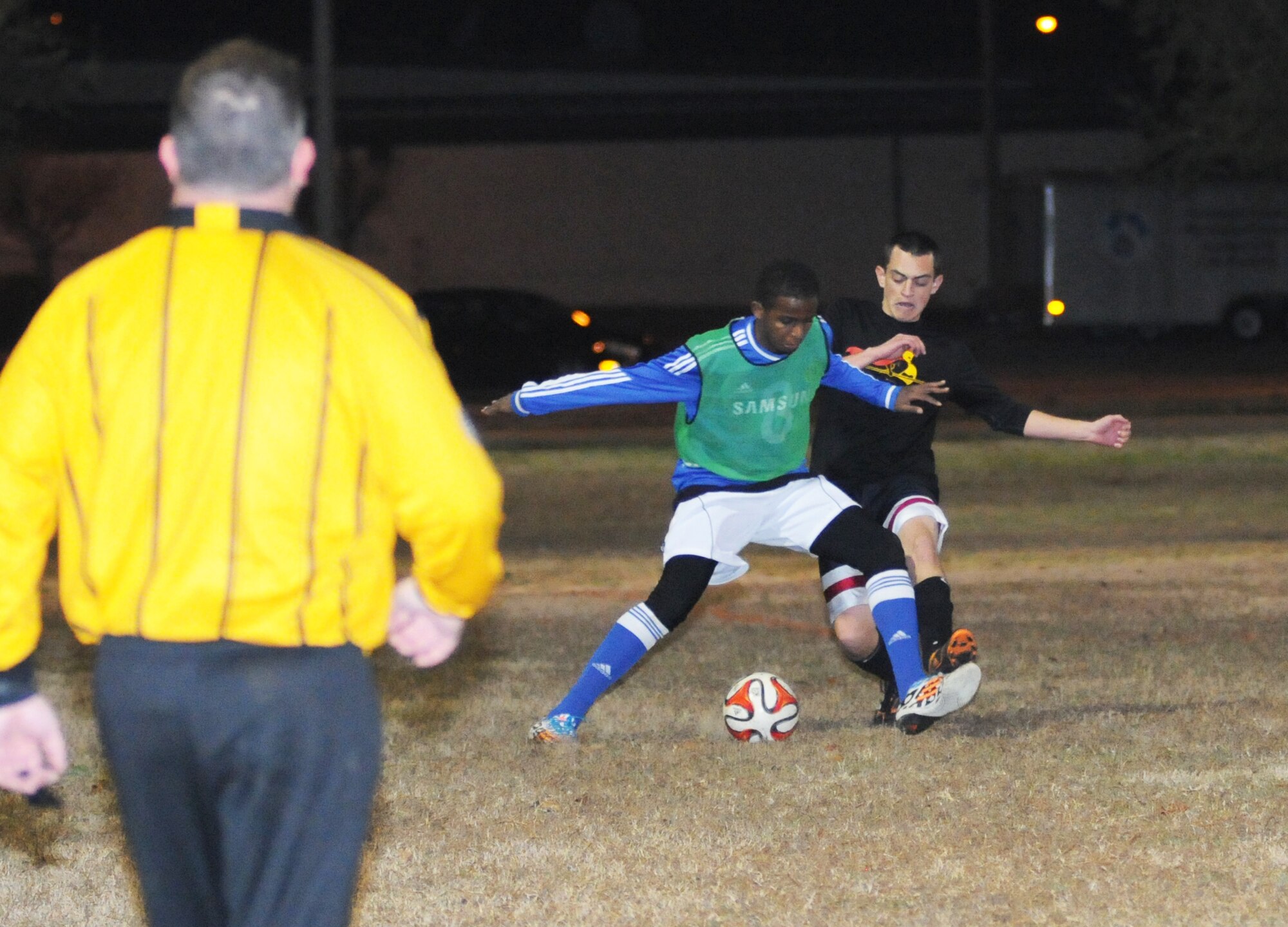 Khalid Alqarni, 81st Dental Squadron, works to control the ball as Kevin Boyajian, 333rd Training Squadron A team, battles for possession during an intramural soccer playoff game Jan. 28, 2015, at Keesler Air Force Base, Miss.  The 333rd TRS–A team defeated 81st DS, 3-2.  The championship game is scheduled for Feb. 4 at 6 p.m.  (U.S. Air Force photo by Kemberly Groue)