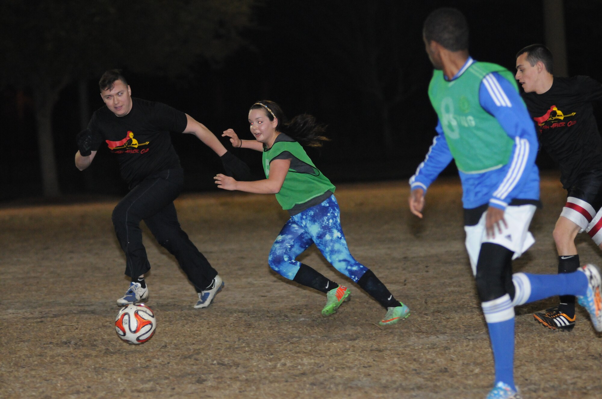 Orlando Saldana Sanchez, 333rd Training Squadron A team, and Abbie Skaggs, 81st Dental Squadron, hustle for the ball during an intramural soccer playoff game Jan. 28, 2015, at Keesler Air Force Base, Miss.  The 333rd TRS–A team defeated 81st DS, 3-2.  The championship game is scheduled for Feb. 4 at 6 p.m.  (U.S. Air Force photo by Kemberly Groue)