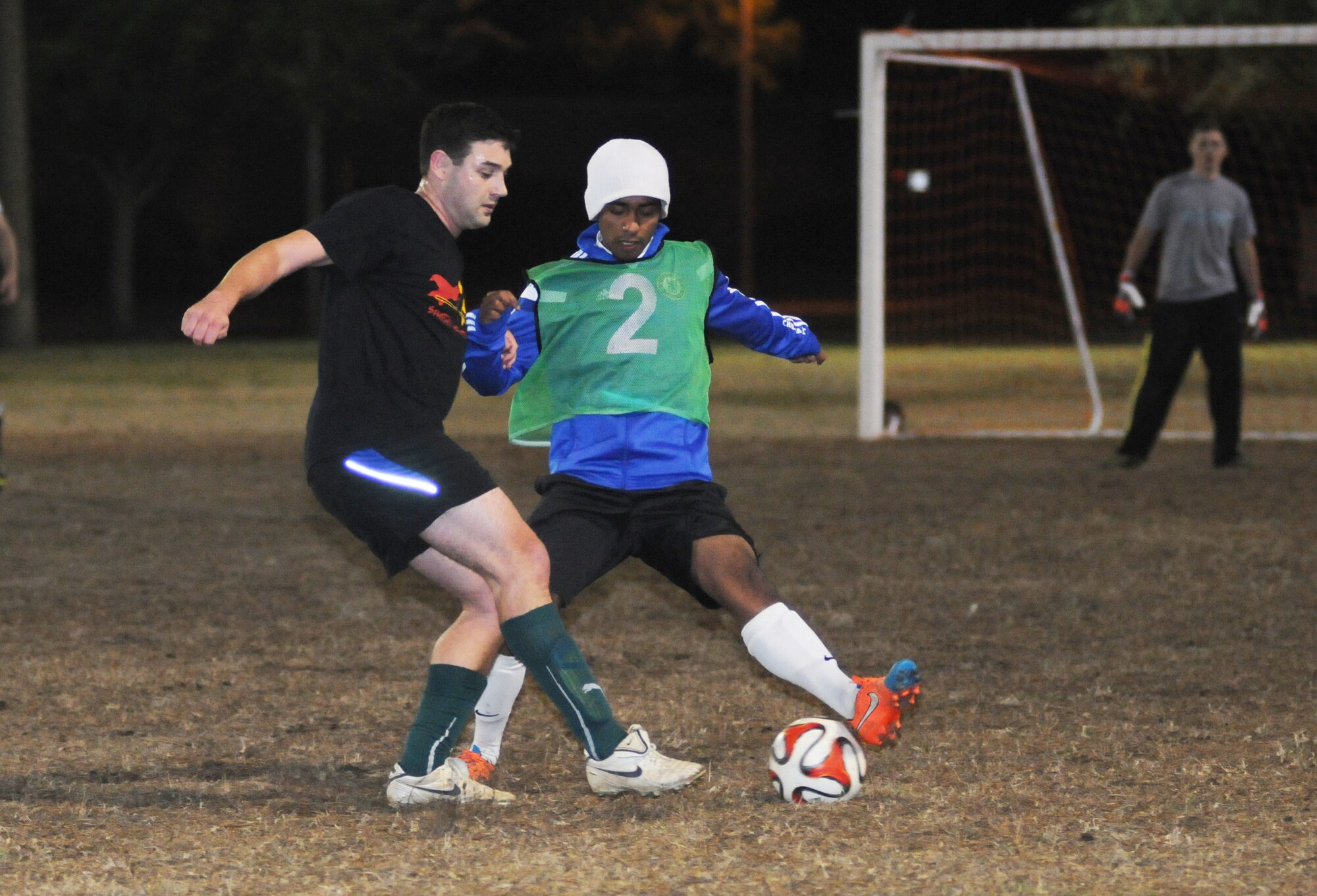 Joseph Schlueter, 333rd Training Squadron A team, and Ahmad Alsabi, 81st Dental Squadron, battle for the ball during an intramural soccer playoff game Jan. 28, 2015, at Keesler Air Force Base, Miss.  The 333rd TRS–A team defeated 81st DS, 3-2.  The championship game is scheduled for Feb. 4 at 6 p.m.  (U.S. Air Force photo by Kemberly Groue)