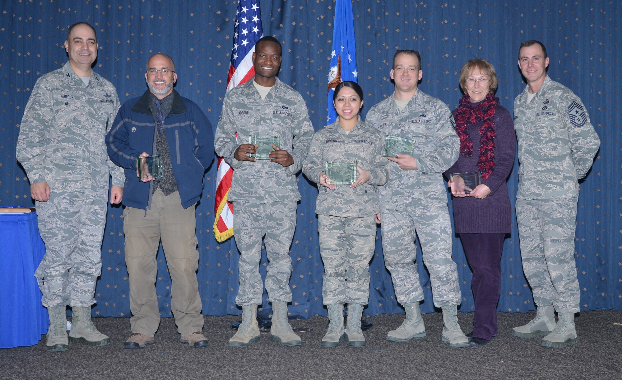 Air Force Nuclear Weapons Center recognized their fourth quarter award winners at a ceremony Jan. 22 at the Mountain View Club.  From left to right: Col. George Farfour, AFNWC vice commander, Raymond Burchell, Staff Sgt. Dominic Kosgei, Airman 1st Class Martha Dirton, Master Sgt. Jeffery Clarke, Dayle Ann Delong, and Chief Master Sgt. Brion Blais, command chief.  Winners not pictured include Capt. David Swanson, Matthew Davis and Duane Sauve. (Photo by Dennis Carlson)