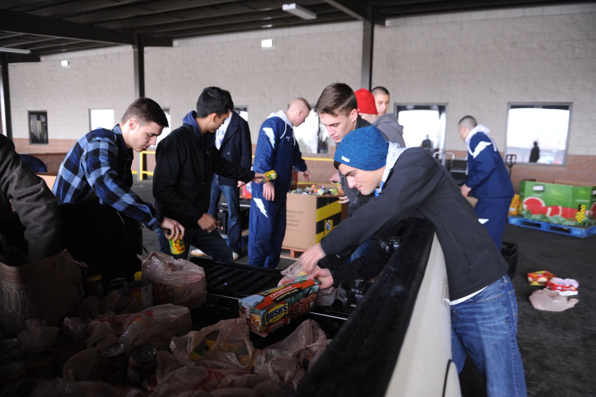 Academy cadets load canned goods into cars for transport during a cadet-run canned food drive for the Care and Share Food Bank Jan. 31, 2015. The cadets collected enough canned and dried foods to fill several pallets. (U.S. Air Force photo/John Van Winkle)