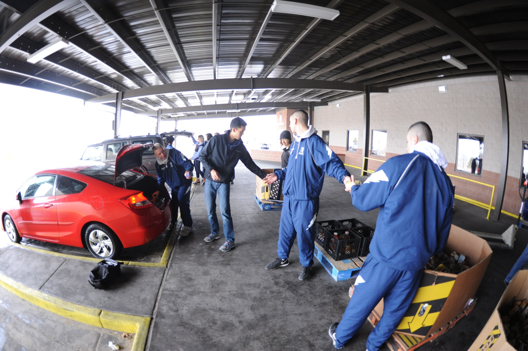 Academy cadets load canned goods into cars for transport during a cadet-run canned food drive for the Care and Share Food Bank Jan. 31, 2015. The cadets collected enough canned and dried foods to fill several pallets. (U.S. Air Force photo/John Van Winkle)