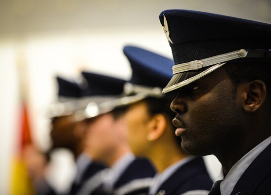 Senior Airman Richard Blackman, 569th U.S.  Forces Police Squadron desk sergeant, stands at attention during the base honor guard graduation ceremony at Ramstein Air Base, Germany, Jan. 30, 2015. Trainees sign up for at least a year of honor guard duty and then complete a week of training on drill and ceremony procedures before participating in official functions. (U.S. Air Force photo/Senior Airman Nicole Sikorski)