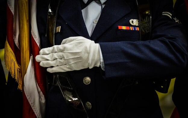 A member of the base honor guard holds the U.S. flag during a presentation of the colors and the playing of the national anthem at Ramstein Air Base, Germany, Jan. 30, 2015. The base honor guard support many functions, official ceremonies and funeral requests. (U.S. Air Force photo/Senior Airman Nicole Sikorski)