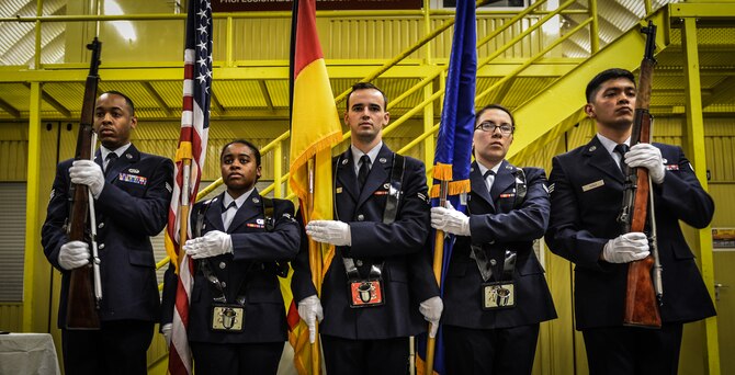 Members of the base honor guard present the colors during their graduation ceremony at Ramstein Air Base, Germany, Jan. 30, 2015. The base honor gaurd holds strong to tradition and ceremony and represent some of the Air Force's most professional and polished Airmen. (U.S. Air Force photo/Senior Airman Nicole Sikorski)