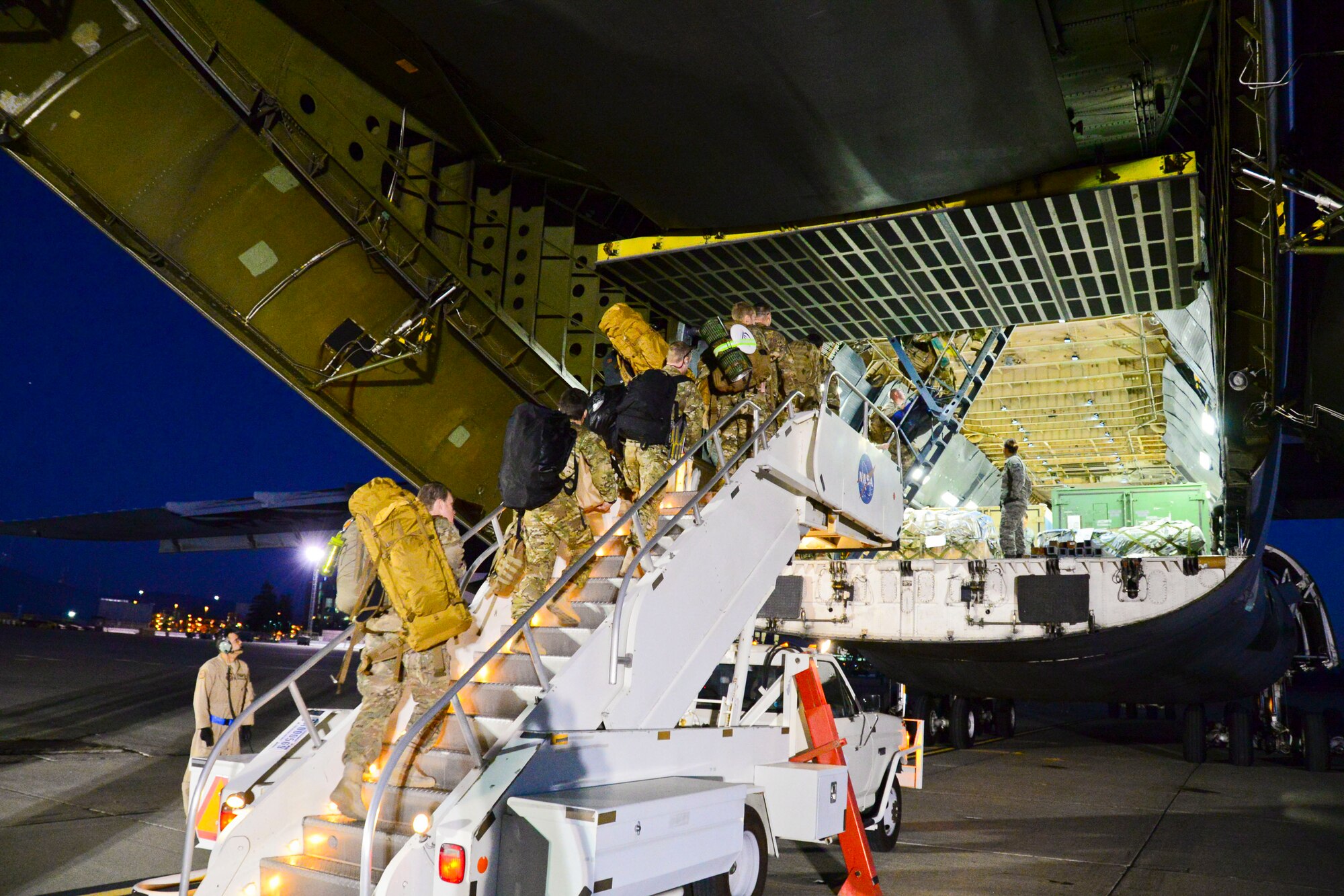 California Air National Guardsmen from the 129th Rescue Wing, Moffett Federal Airfield, Calif., prepare to board a C-5 Galaxy aircraft for their overseas deployment. (U.S. California Air National Guard photo by 1st Lt Roderick Bersamina)
