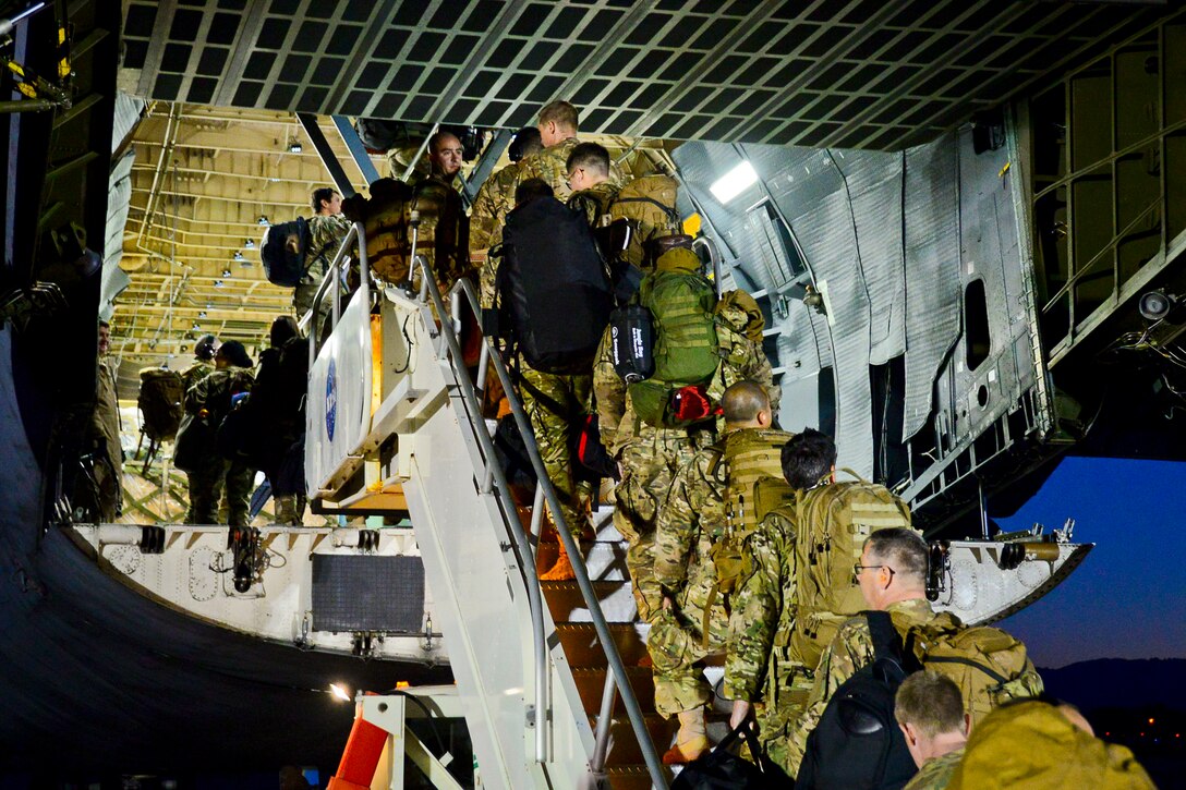 California Air National Guardsmen from the 129th Rescue Wing, Moffett Federal Airfield, Calif., prepare to board a C-5 Galaxy aircraft for their overseas deployment. (U.S. California Air National Guard photo by 1st Lt Roderick Bersamina)