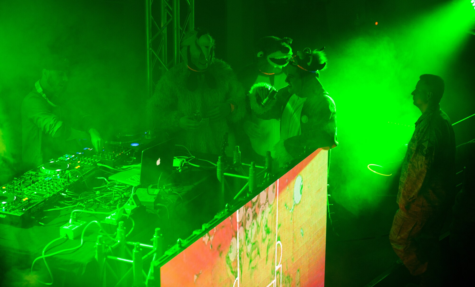 Members of the Kaiserslautern Military Community talk with Disc Jockey SuperVision, as he plays for the troops at Ramstein Air Base, Germany, Jan. 30, 2015. SuperVision and three other DJs played for Airmen, Soldiers and civilians on base as part of a USO Electronic Dance Music tour. (U.S. Air Force photo/Senior Airman Armando A. Schwier-Morales)