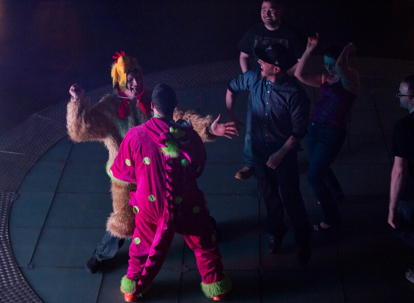 Disc jockey SuperVision, middle, USO Electronic Dance Music tour DJ, dances with military members during a visit at Ramstein Air Base, Germany, Jan. 31, 2015. The 86th Force Support Squadron and the USO hosted four DJs to play for the troops. (U.S. Air Force photo/Senior Airman Armando A. Schwier-Morales)