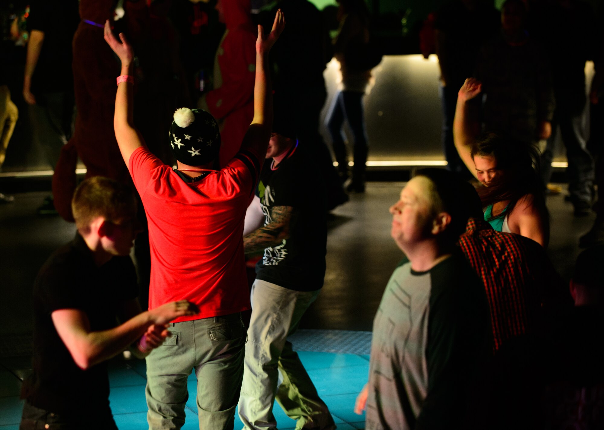 Members of the Kaiserslautern Military Community dance to Electronic Dance Music at Ramstein Air Base, Germany, Jan. 30, 2015. Four disc jockeys played for the troops during the USOs EDM tour that started at Ramstein. (U.S. Air Force photo/Senior Airman Armando A. Schwier-Morales)