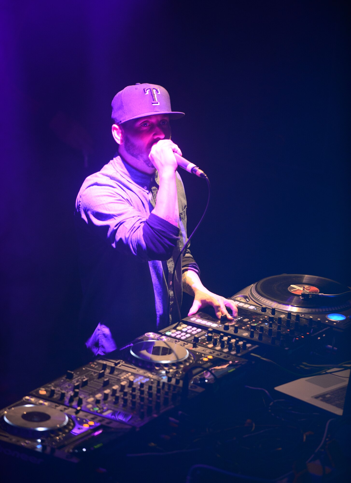 Disc Jockey SuperVision thanks the troops during a performance at the enlisted club at Ramstein Air Base, Germany, Jan. 30, 2015. Airmen, Soldiers and civilians joined in on the USOs first overseas Electronic Dance Music tour. (U.S. Air Force photo/Senior Airman Armando A. Schwier-Morales)