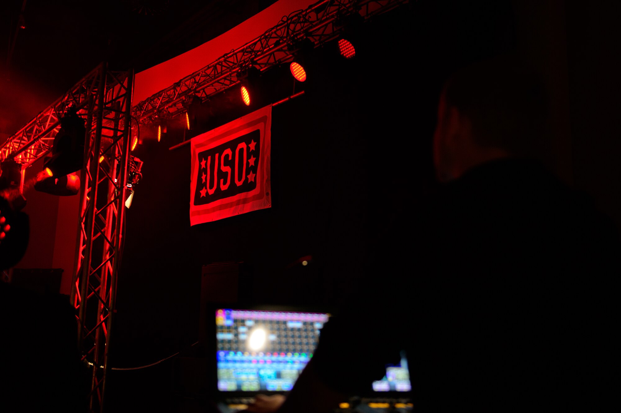 A technician for the USO Electronic Dance Music tour manages the light display as a disc jockey plays for the troops at Ramstein Air Base, Germany, Jan. 30, 2015. The USO and Ramstein’s 86th Force Support Squadron hosted four Djs. (U.S. Air Force photo/Senior Airman Armando A. Schwier-Morales)