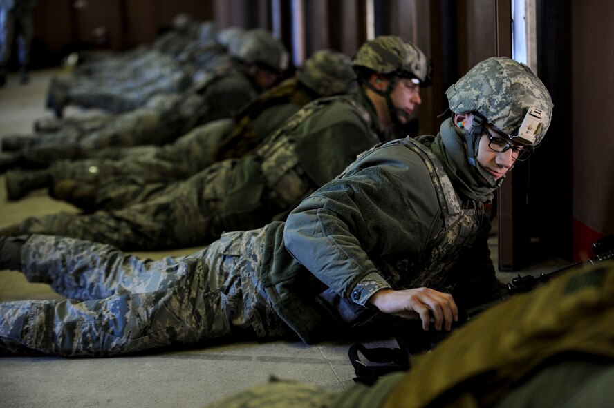 Airman 1st Class Adam Lester, 5th Security Forces Squadron bravo flight member, reaches for an M4 rifle magazine during training at the combat arms training and maintenance range on Minot Air Force Base, N.D., Jan. 12, 2015. During training, Lester was instructed on breathing techniques as well as other ways to keep his shots consistent. (U.S. Air Force photo/Senior Airman Stephanie Morris)