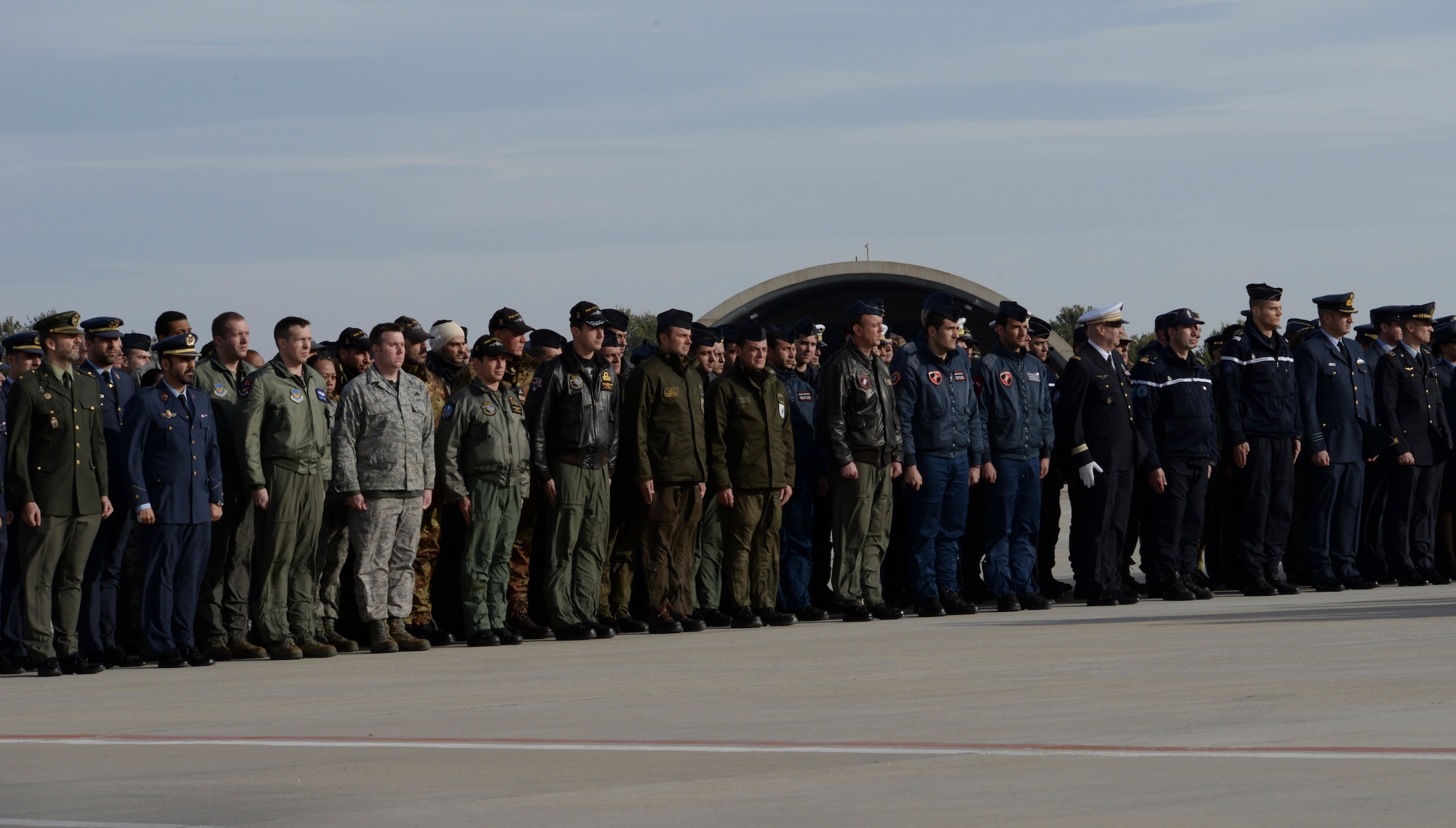 Airmen of the 492nd Fighter Squadron pay their respects alongside NATO allies at a memorial service honoring fallen members of the French Air Force at Los Llanos Air Base, Spain, Jan. 29, 2015. Eleven airmen from the Greek and French air forces lost their lives following an aircraft accident at Tactical Leadership Programme 2015-1, a flying course that develops leadership and interoperability amongst NATO allies. (U.S. Air Force photo by Airman 1st Class Erin R. Babis/Released)