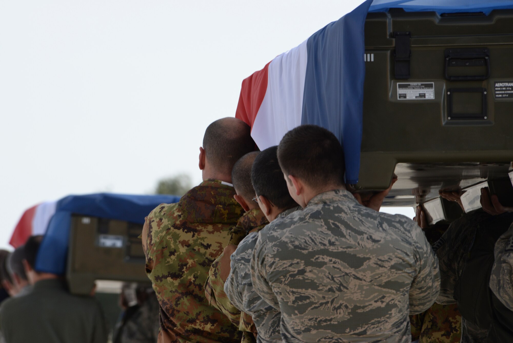 Airmen of the 492nd Fighter Squadron help carry nine fallen members of the French air force during a memorial service at Los Llanos Air Base, Spain, Jan. 29, 2015. Eleven airmen from the Greek and French air forces lost their lives following an aircraft accident at Tactical Leadership Programme 2015-1, a flying course that develops leadership and interoperability amongst NATO allies. (U.S. Air Force photo by Airman 1st Class Erin R. Babis/Released)
