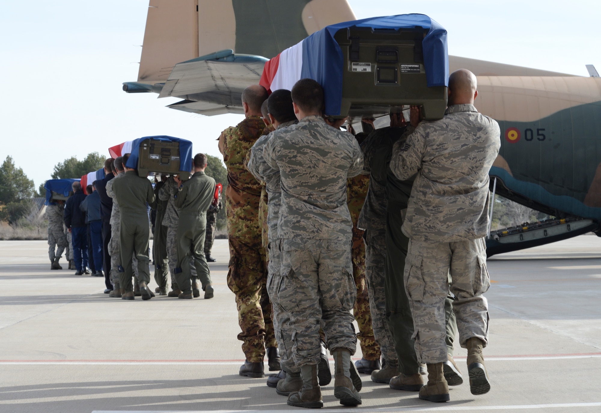 Participants of the Tactical Leadership Programme 2015-1, including Airmen of the 492nd Fighter Squadron, carry nine fallen members of the French air force during a memorial service at Los Llanos Air Base, Spain, Jan. 29, 2015. Eleven airmen from the Greek and French air forces lost their lives following an aircraft accident at Tactical Leadership Programme 2015-1, a flying course that develops leadership and interoperability amongst NATO allies. (U.S. Air Force photo by Airman 1st Class Erin R. Babis/Released)