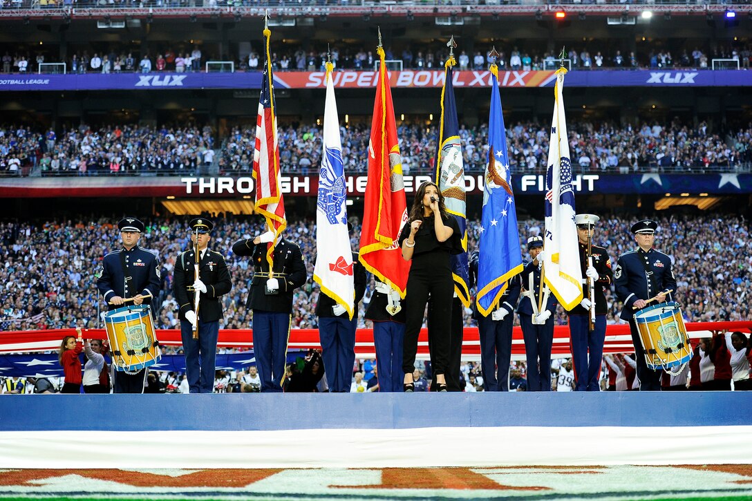 Members of the Joint Armed Forces Color Guard perform during opening ceremonies for Super Bowl XLIX at the University of Phoenix Stadium in Glendale, Ariz., Feb. 1, 2015. Entertainer Idina Menzel sang the national anthem. 