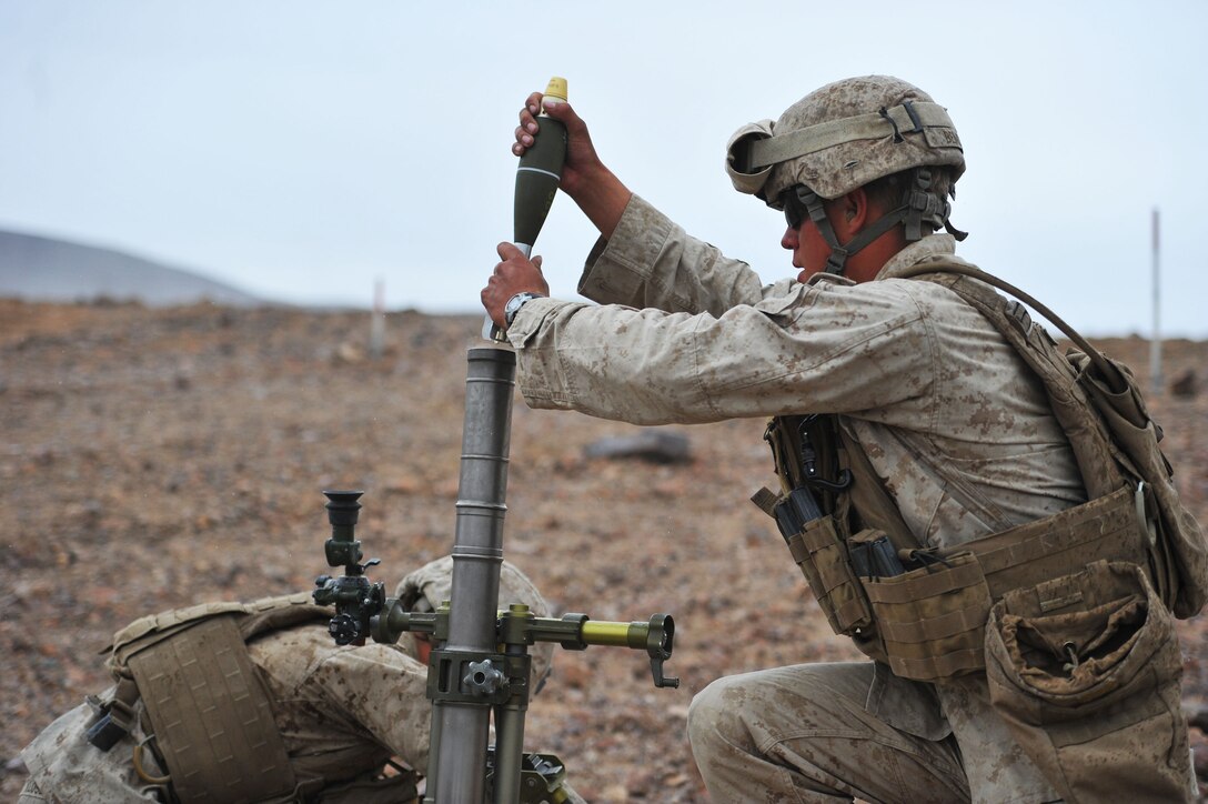 Marines fire their 60mm mortar while participating in a company attack during Integrated Training Exercise 2-15 at the Marine Corps Air Ground Combat Center in Twentynine Palms, Calif., Jan. 26, 2015. 