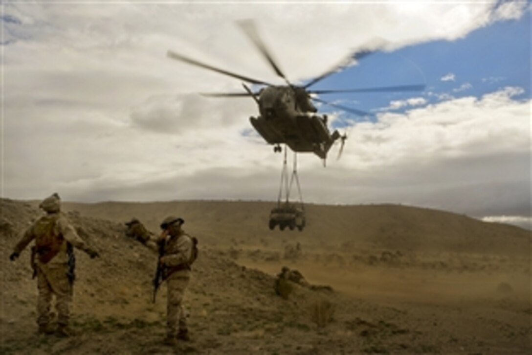 A Marine guides a CH-53E Super Stallion helicopter to the landing zone while participating in an air assault course event during the Integrated Training Exercise 2-15 at the Marine Corps Air Ground Combat Center in Twentynine Palms, Calif., Jan. 31, 2015. 