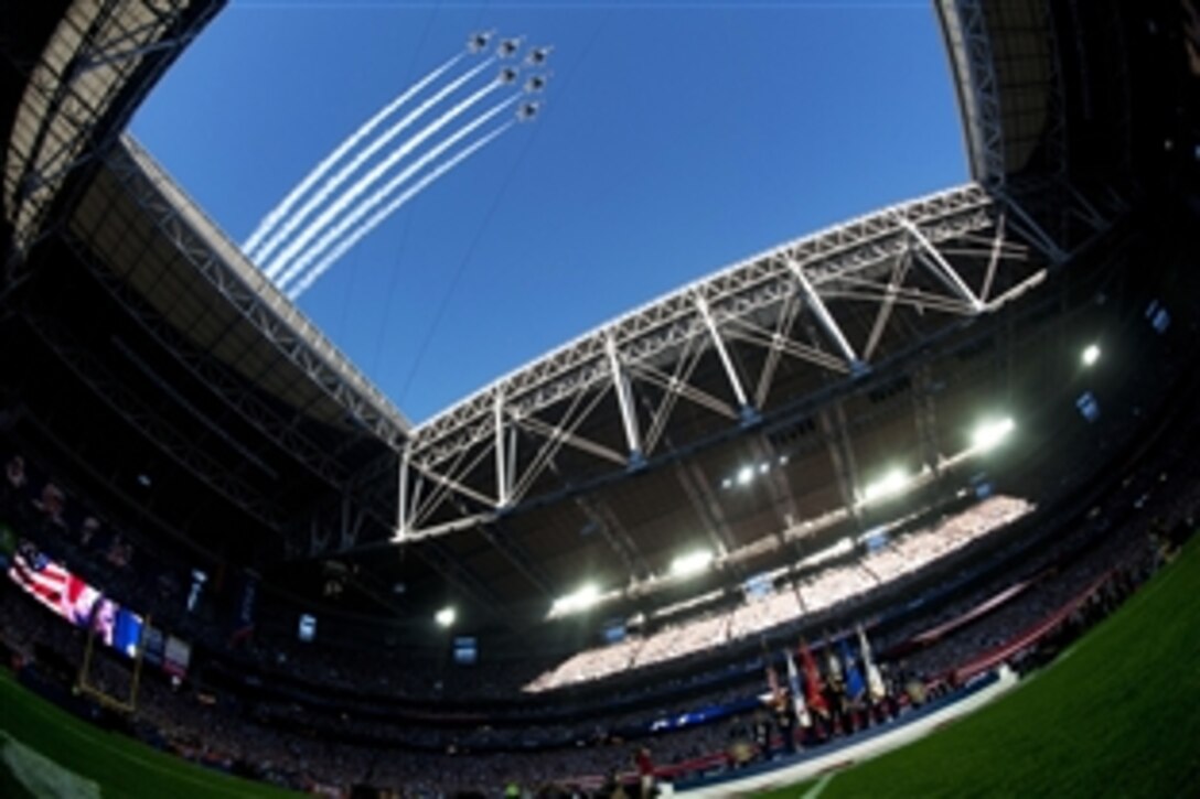 The U.S. Air Force Thunderbirds fly over during opening ceremonies for Super Bowl XLIX at the University of Phoenix Stadium in Glendale, Ariz.., Feb. 1, 2015. Members of the Joint Armed Forces Color Guard also performed during the event. 