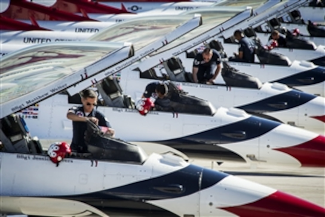 Airmen prepare their aircraft on Nellis Air Force Base, Nev., Feb. 1, 2015, to fly over the Super Bowl during the event later in the day. The airmen are assigned to the Air Force Thunderbirds air demonstration squadron.