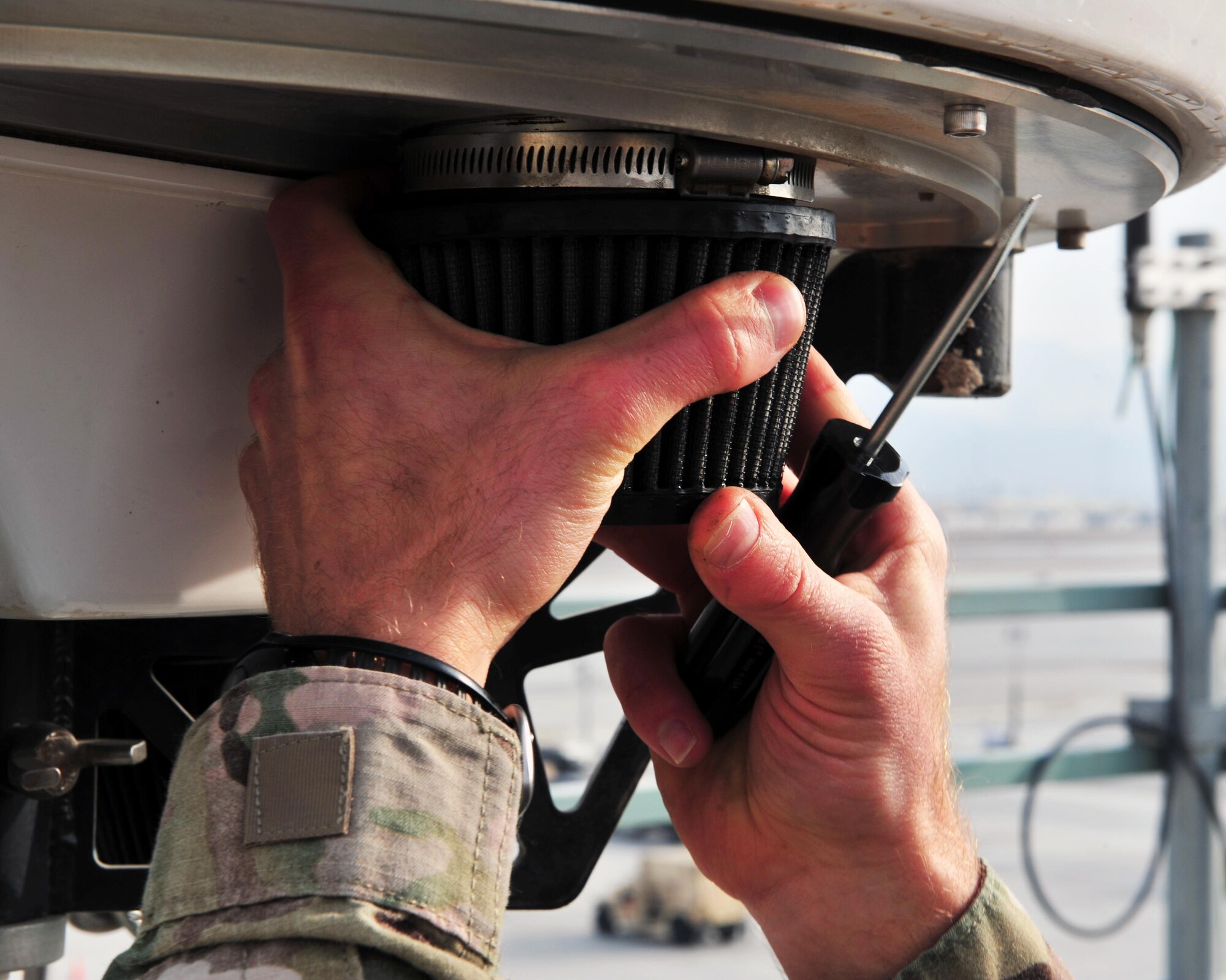 U.S. Air Force Tech. Sgt. Timothy Lawson, 455th Expeditionary Operations Support Squadron’s weather flight chief, unscrews a filter on meteorological equipment used to predict impending precipitation, Jan. 28, 2015 at Bagram Airfield, Afghanistan. Airmen assigned to the weather flight provide up-to-the-minute recommendations to pilots flying missions throughout the Area of Responsibility. (U.S. Air Force photo by Staff Sgt. Whitney Amstutz/released)