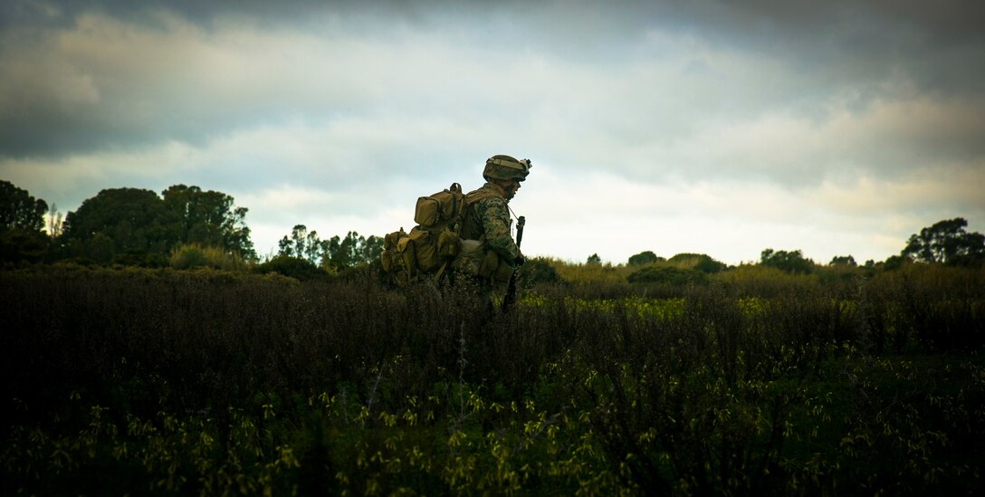 A Marine with Special-Purpose Marine Air-Ground Task Force Crisis Response – Africa walks through a field at Rota Air Base, Spain, during an unscripted medical evacuation drill Jan. 29, 2015. A platoon of Marines from SPMAGTF-CR-AF departed Morón Air Base, Spain, within hours of receiving a mission to retrieve a simulated casualty.  (U.S. Marine Corps photo by Sgt. Paul Peterson/Released)