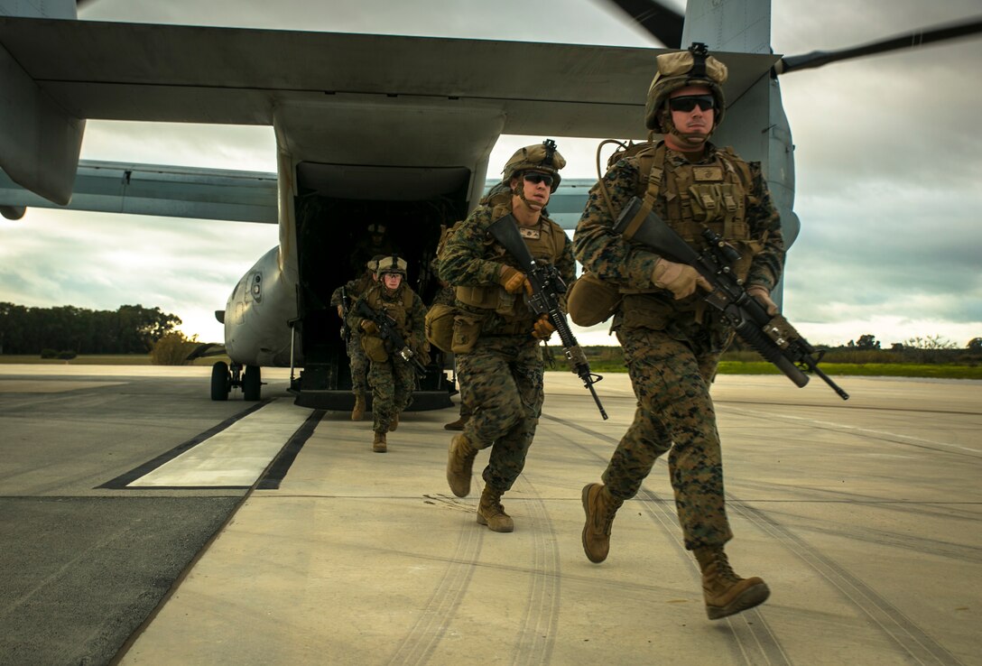 Sgt. Brandon Woodard, a squad leader with Special-Purpose Marine Air-Ground Task Force Crisis Response – Africa, leads his Marines out of an MV-22 Osprey during an alert-force drill at Rota Air Base, Spain, Jan. 29, 2015. Woodard pushed his team of Marines several hundred meters from their landing site to evacuate a simulated casualty while another squad of Marines maintained security at the unit’s extraction point.  (U.S. Marine Corps photo by Sgt. Paul Peterson/Released)