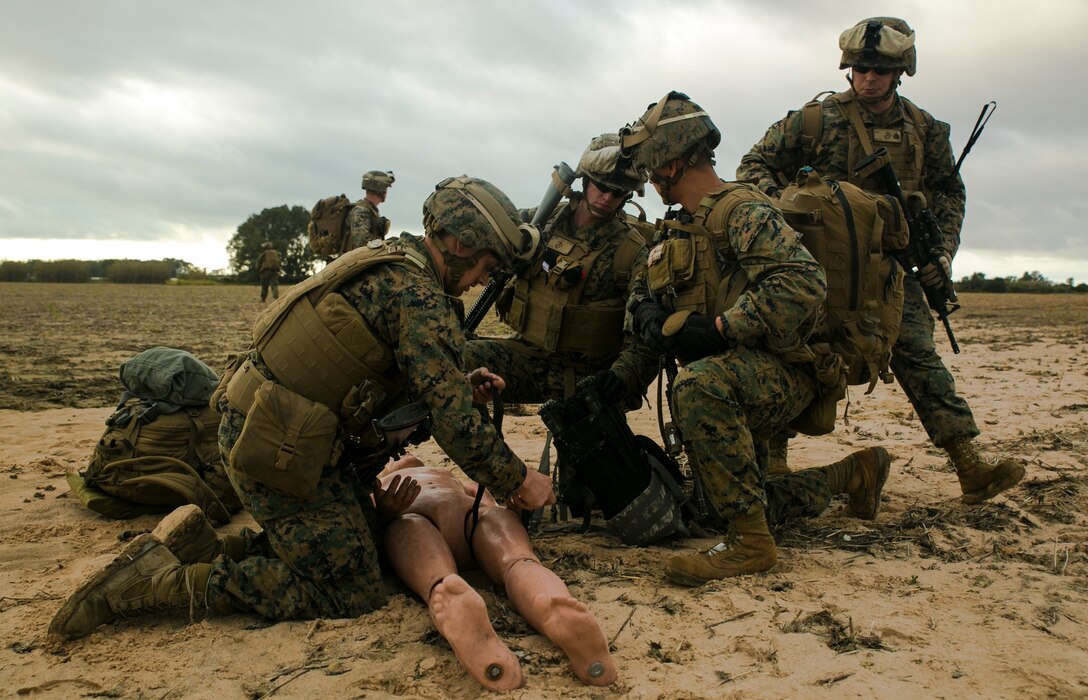 Marines with Special-Purpose Marine Air-Ground Task Force Crisis Response – Africa treat a simulated casualty for a gunshot wound to the leg during an alert-force drill at Rota Air Base, Spain, Jan. 29, 2015. A platoon of Marines secured the casualty and an extraction point nearby as a test of the unit’s ability to rapidly respond to regional crises. (U.S. Marine Corps photo by Sgt. Paul Peterson/Released)