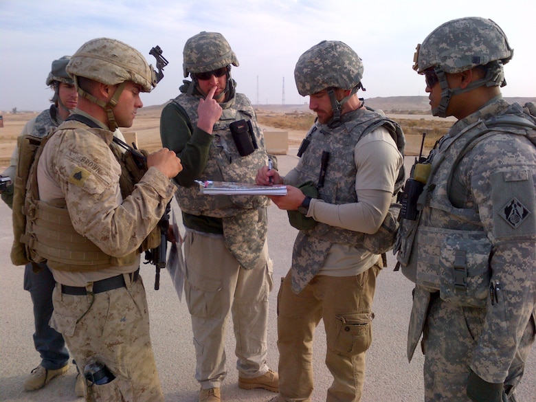 SOUTWEST ASIA - Members of the 62nd Forward Engineer Support Team discuss infrastructure needs with the Marines in Iraq. 