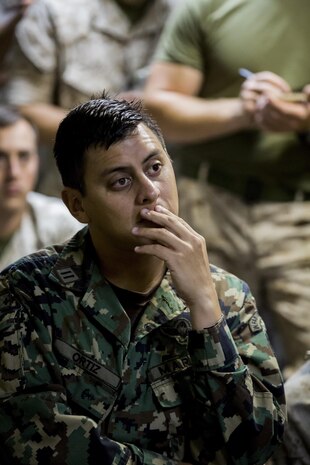 Mexican Marine 1st Lt. Manuel Ortiz with Headquarters and Service Company, 2nd Battalion 6th Marines, listens to a brief on the upcoming events during exercise Bold Alligator 14, on the USS Kearsarge (LHD3), Oct. 30, 2014. Exercise Bold Alligator 14 is a multi-national, synthetic naval exercise designed to train the full range of amphibious capabilities in order to provide unique and contemporary solutions to global challenges.