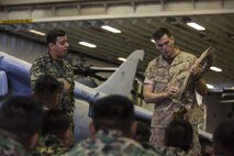 U.S. Marine 2nd Lt. Adam Casey teaches Mexican Marines  safety precautions in the event of an emergency on the USS Kearsarge (LHD-3) during exercise Bold Alligator 14, off the eastern coast of the United States, Nov. 1, 2014. Exercise Bold Alligator 14 is a multi-national, synthetic naval amphibious exercise designed to train across the full range of amphibious capabilities in order to provide unique and contemporary solutions to global challenges.