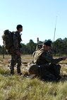 British Royal Marines assigned to 4th Troop, Kilo Company establish communications during a humanitarian training scenario part of Exercise Bold Alligator on Landing Zone Dolphin, Atlantic, N.C., Nov. 3, 2014. Exercise Bold Alligator is a multi-national, synthetic naval amphibious exercise designed to train across the full range of amphibious capabilities in order to provide unique and contemporary solutions to global challenges.