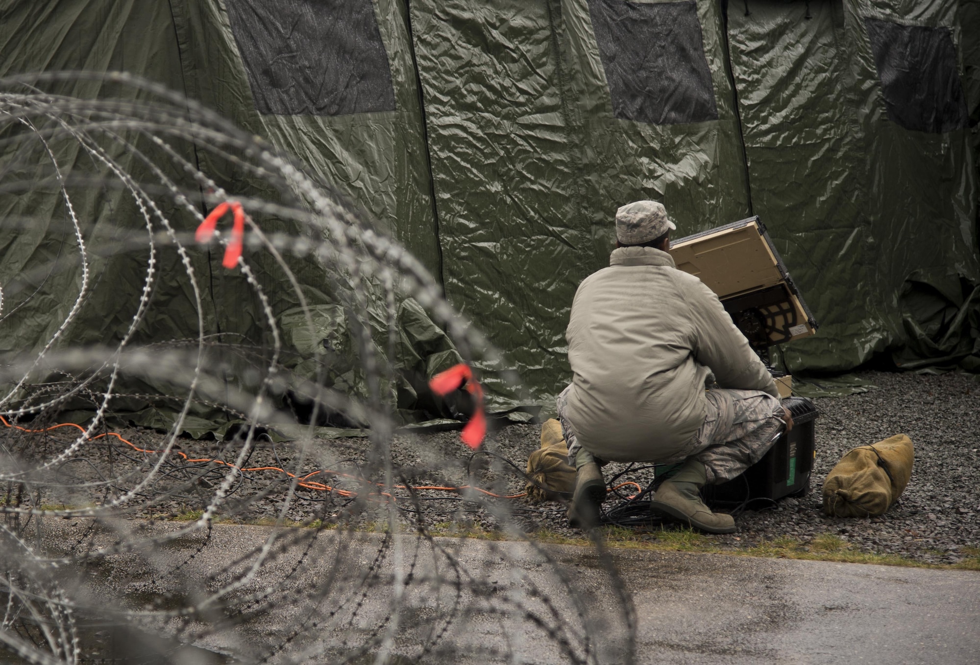 Airman 1st Class Lamar Richerson manages a satellite dish during exercise Juniper Thunder Jan. 29, 2015, on Ramstein Air Base, Germany. Juniper Thunder is a joint communications exercise between Air Force and Army members with the focus on establishing bilateral communications across the two branch’s networks. Richerson is a transmissions systems technician assigned to the 1st Combat Communications Squadron. (U.S. Air Force photo/Senior Airman Jonathan Stefanko)