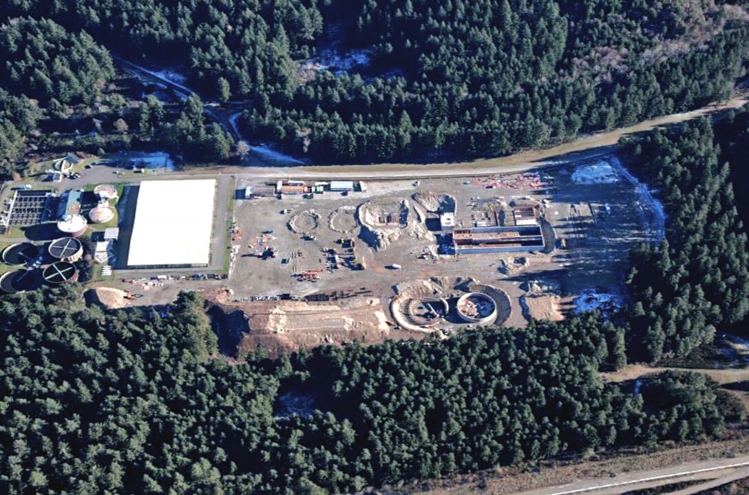 The photo shows an overhead view of the progress made on construction of the Waste Waster Treatment Facility at Joint Base Lewis-McChord, Washington.  Unlike most military construction projects at JBLM, which consist of constructing mission facilities on a project site, the WWTP is also a process facility. That means in addition to the challenges of constructing a 15-acre complex of interconnected facilities and infrastructure, Seattle District and contractor CDM-Smith are also designing and initiating an entirely new wastewater treatment process to comply with current operating permit criteria, while posturing the WWTP for future population growth and operating conditions 50 years or more into the future.