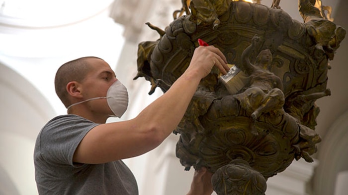 Lance Cpl. Louis Bardel, a mortarman with Special-Purpose Marine Air-Ground Task Force Crisis-Response, Detachment A dusts a chandelier inside the Church of San Nicolo in Catania, Italy, Jan. 31. More than 20 Marines and Sailors assigned to SPMAGTF-CR-AF travelled from Naval Air Station Sigonella to Catania to help beautify the nearly 1,000-year-old church. (U.S. Marine Corps photo by Lance Cpl. Lucas J. Hopkins/Released)