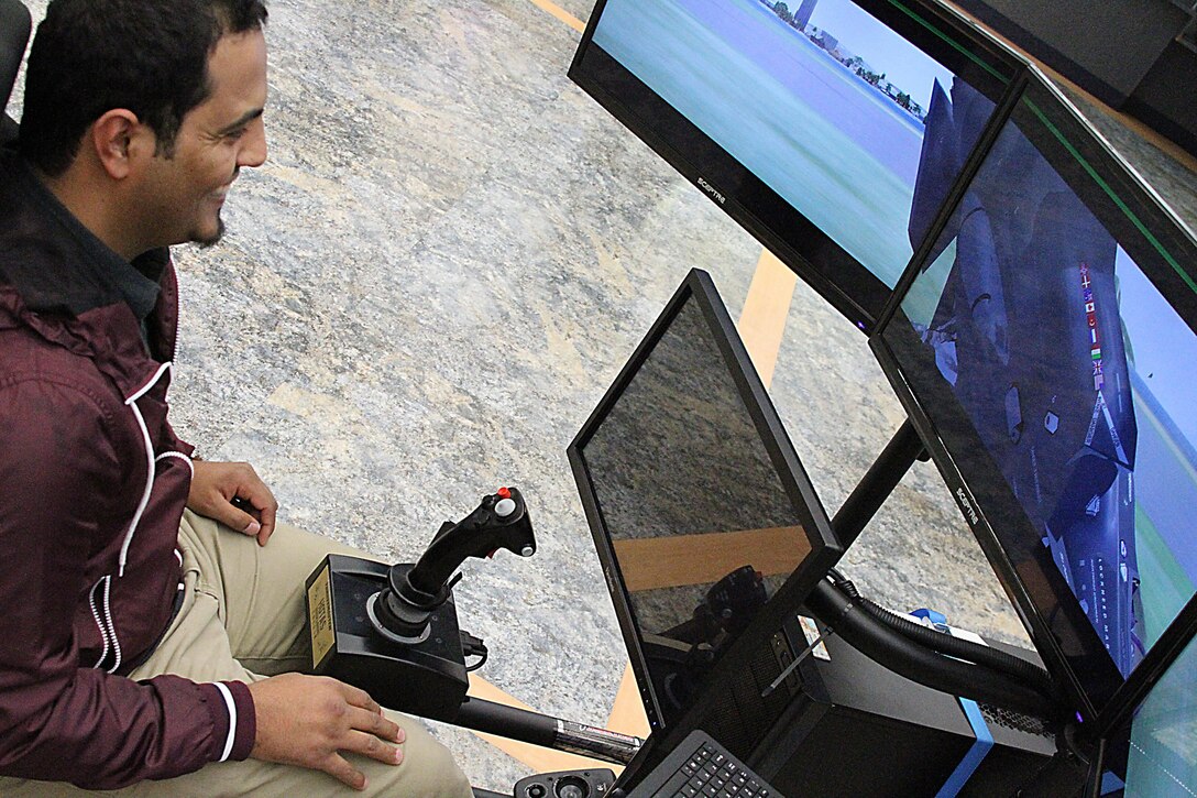 West Virginia University student Abdullah Lasharari, a Saudi Arabia native, flies a 4th Marine Corps District Flight Simulator at a recruiting event, Morgantown, West Virginia Jan. 23, 2015. The program helps identify students who would be interested in an aviation career with the Marines.  (U.S. Marine Corps photo by Cpl. Amber Williams/Released)