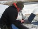 Park Ranger Jason Cote downloads data from a data logger on a tributary to Shenango Lake.